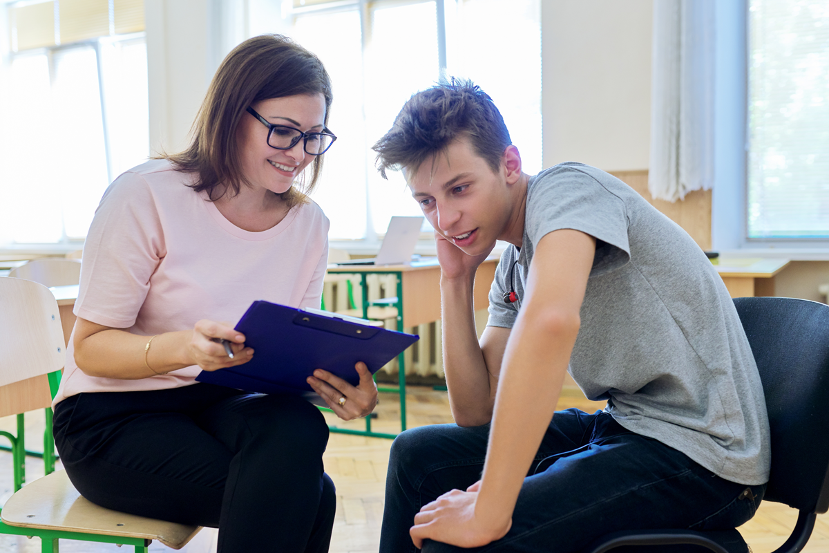 14 year old boy receiving support from paraprofessional