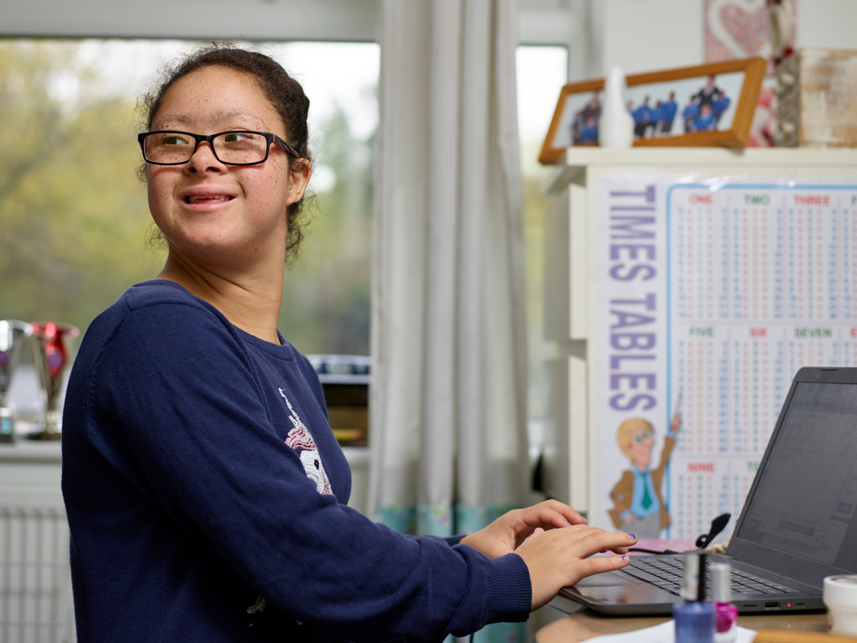 autistic student on computer being independent
