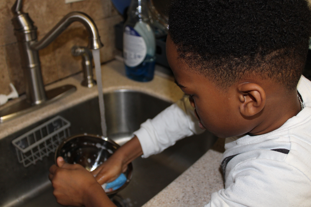 student learning to wash dishes
